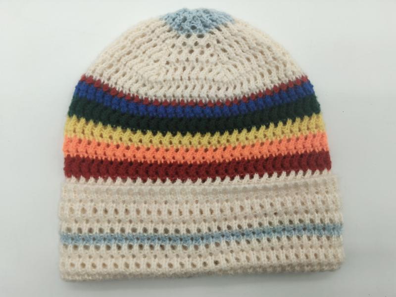 Handmade crochet beanie hat in cream with multicolor rainbow stripes including blue, green, yellow, orange and red bands