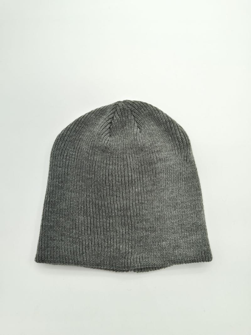 Flat lay of a heather gray ribbed knit beanie hat on white background, showing fine knit texture and tapered crown