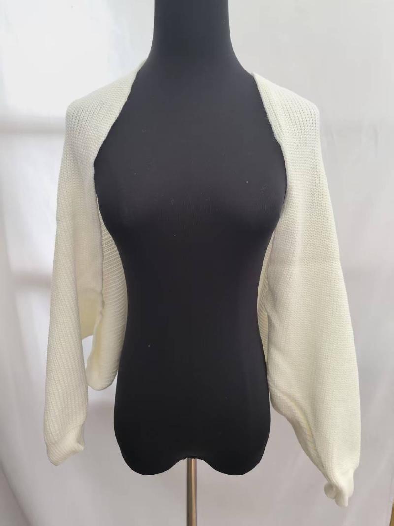 Cream chunky knit open front bolero shrug with long sleeves displayed on a black dress mannequin against white background