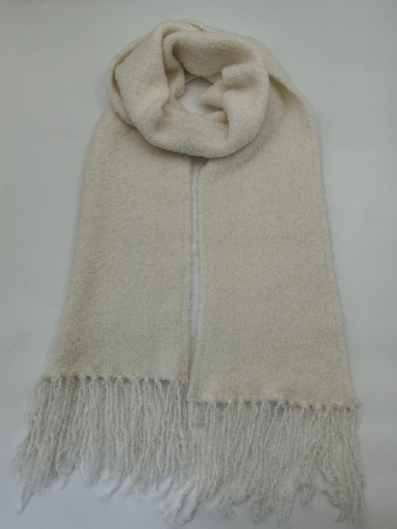 Ivory cream boucle wool blend scarf with fringe ends, looped and laid flat on white background