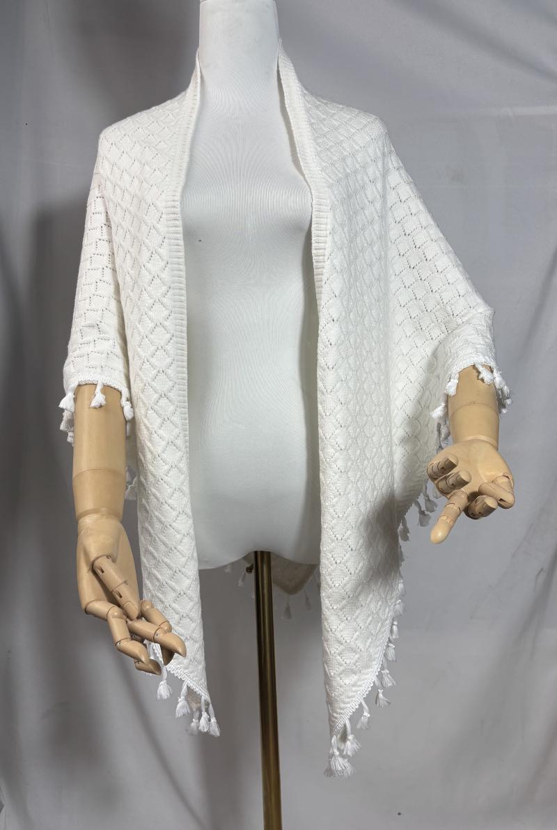 Ivory open-front diamond knit wrap shawl with white tassel fringe trim displayed on a dress form mannequin
