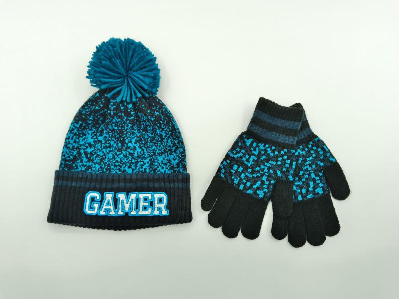 Kids teal and black knit gamer beanie hat with pom-pom and matching pixel-pattern gloves set on white background