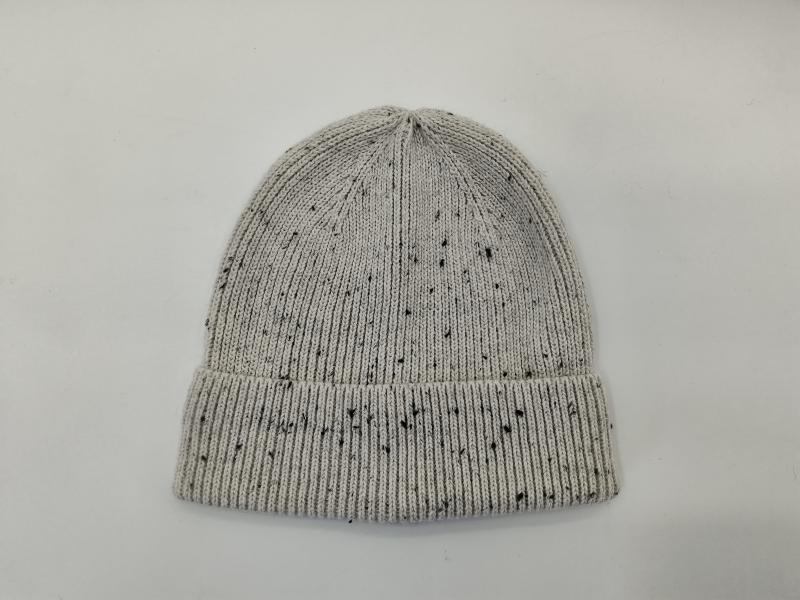 Light grey ribbed knit beanie hat with black speckle fleck pattern and folded cuff, laid flat on white background