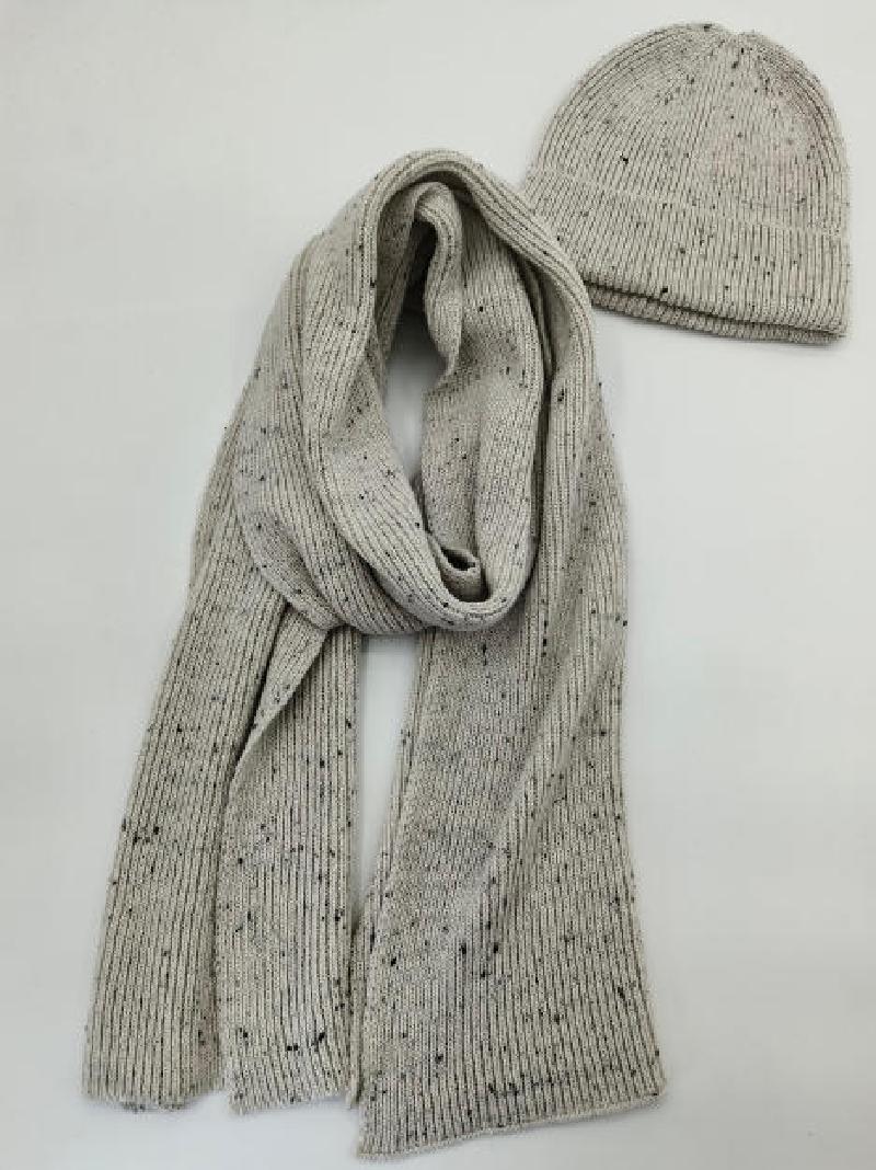Light grey ribbed knit scarf and matching beanie hat set with dark fleck speckle pattern on white background