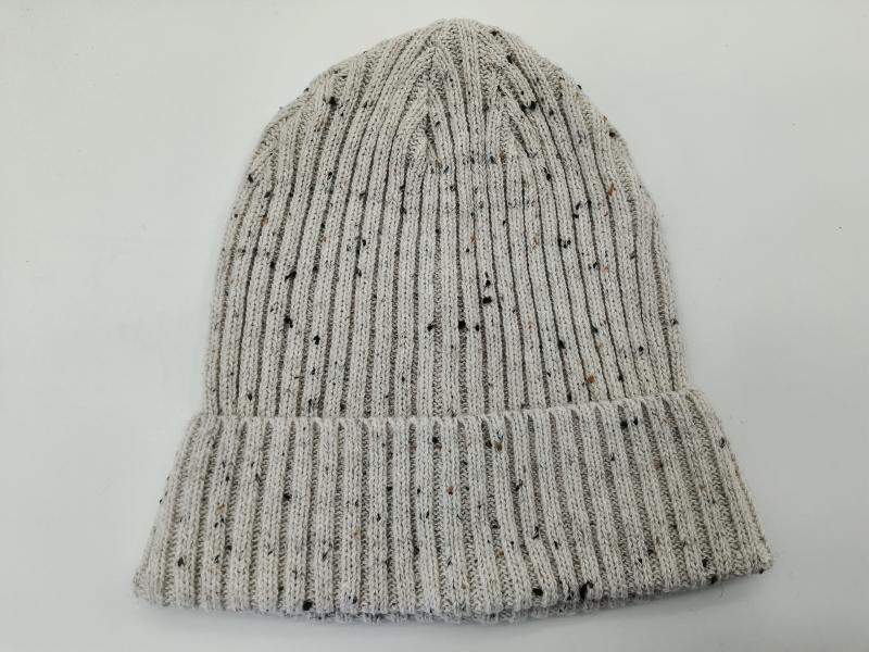 Light grey ribbed knit beanie hat with multicolor fleck tweed pattern and folded cuff, laid flat on white background