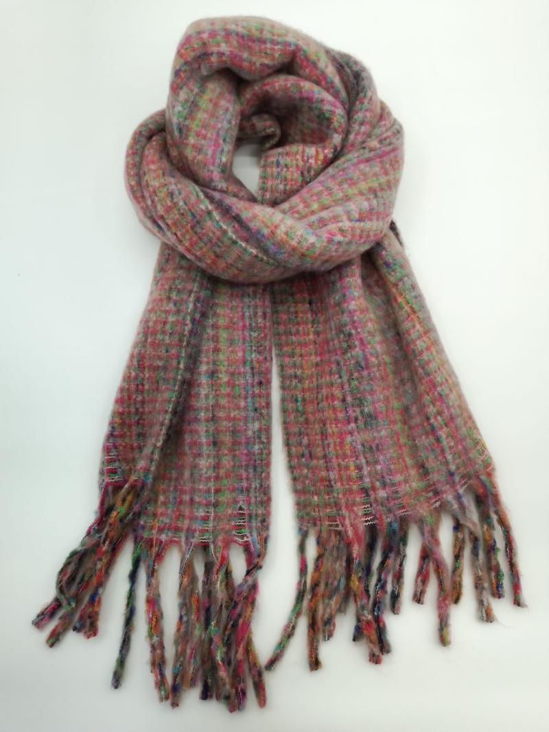 Pink multicolor plaid knit scarf coiled and laid flat showing colorful fringe ends on white background