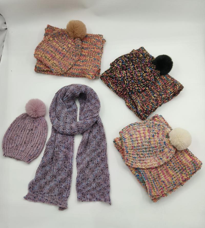 Four knitted winter hat and scarf sets in multicolor speckled yarn with faux fur pompoms, plus a purple knit beanie and long scarf