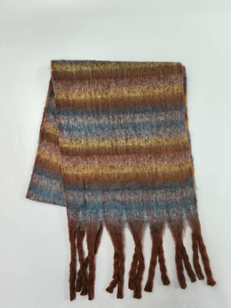 Folded fuzzy striped scarf in brown, gold, blue, and mauve with twisted fringe ends on white background
