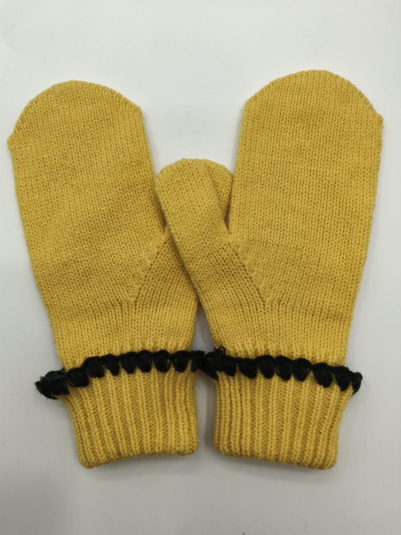 Pair of mustard yellow knitted winter mittens with ribbed cuffs and black decorative pom-pom trim detail