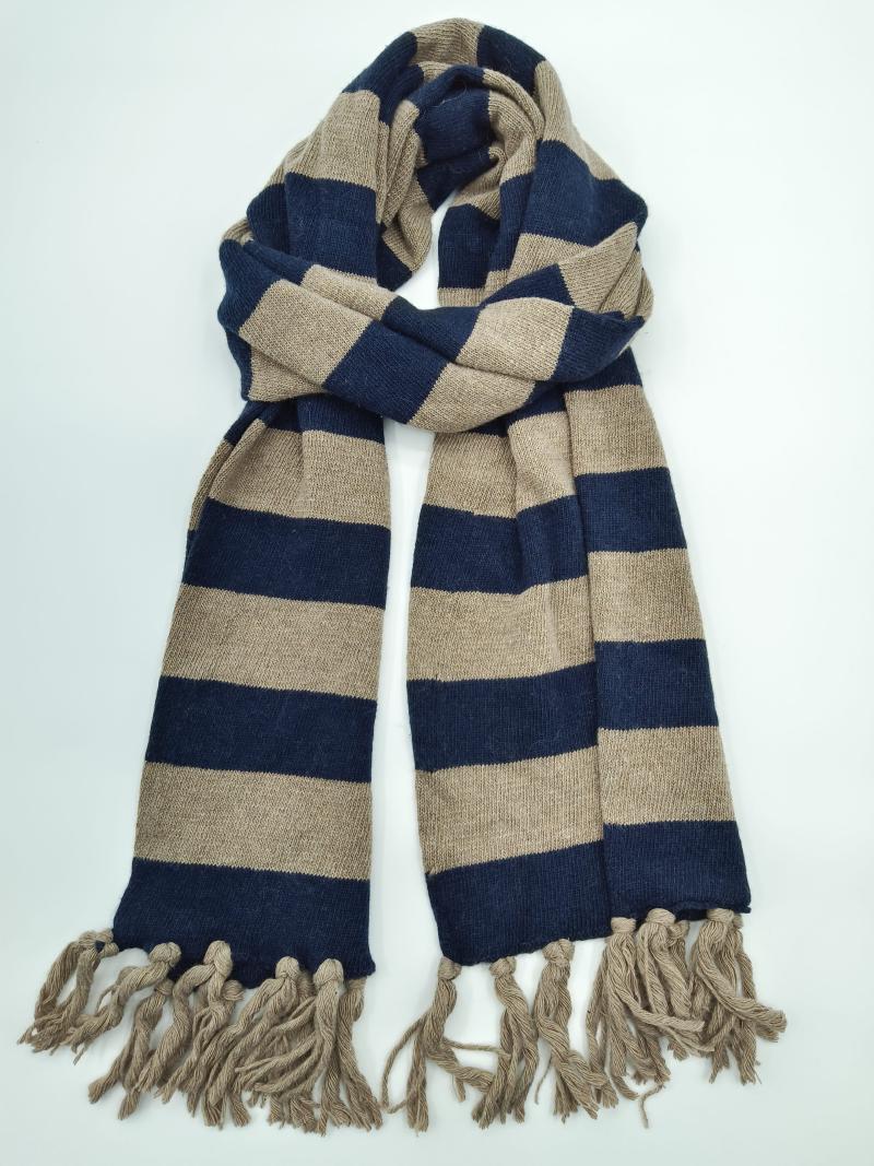 Knitted navy blue and beige wide stripe scarf with fringe tassels, loosely knotted on white background