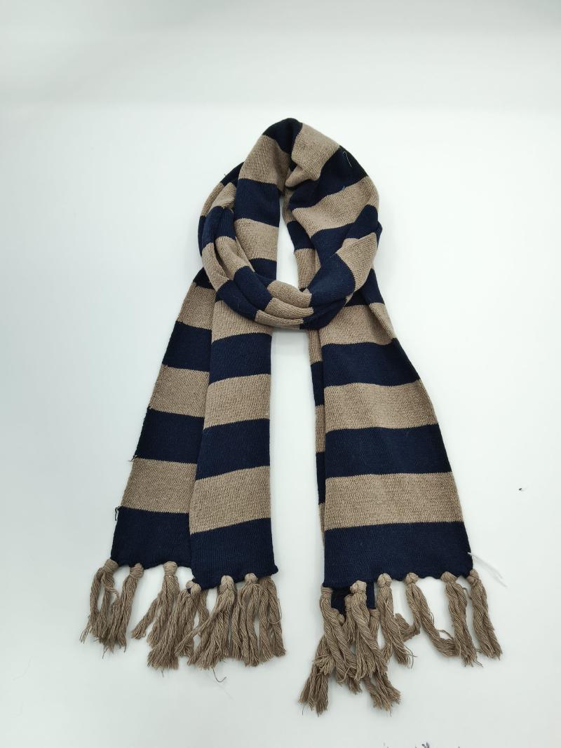 Striped navy blue and beige knit winter scarf looped on white background with tassel fringe ends