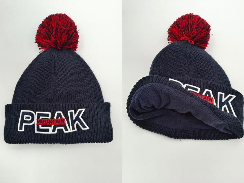 Navy blue ribbed knit beanie with red pom-pom and embroidered PEAK MOUNTAIN logo on folded cuff, front and interior view