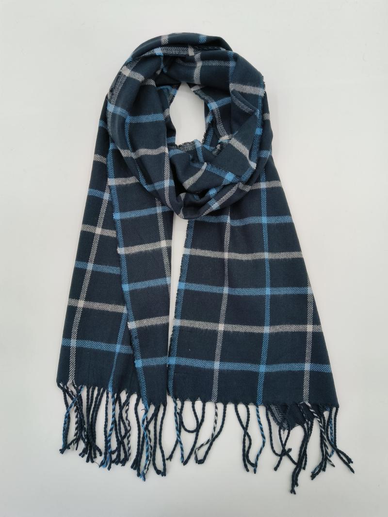 Folded navy blue plaid tartan scarf with light blue and white checks and twisted fringe ends on white background
