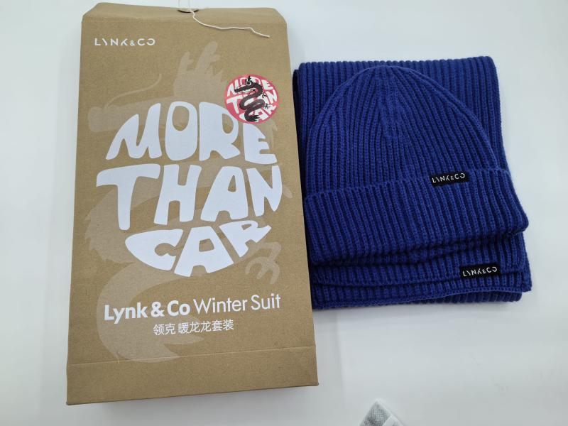 Navy blue ribbed knit beanie hat and matching scarf winter accessory set displayed beside kraft paper gift box