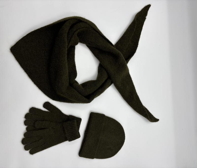 Olive green knit winter accessories set with triangle scarf, matching gloves and beanie hat on white background