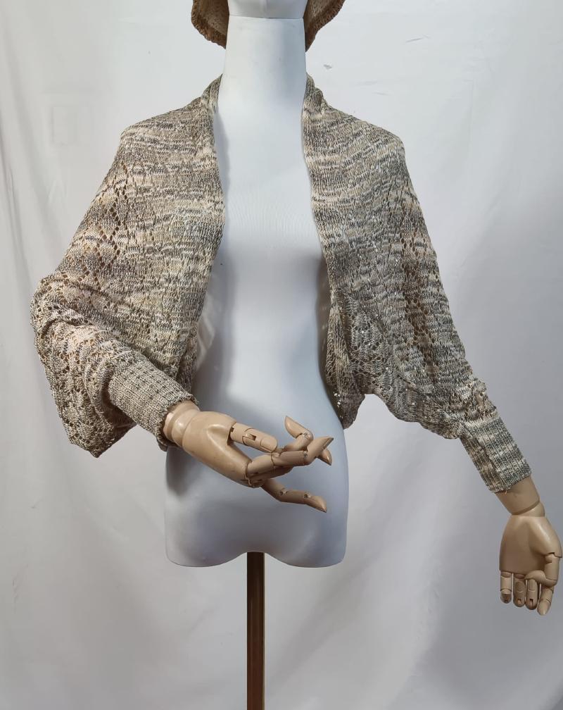 Lace knit open-front shrug bolero in beige grey marl displayed on a mannequin with wooden articulated hands