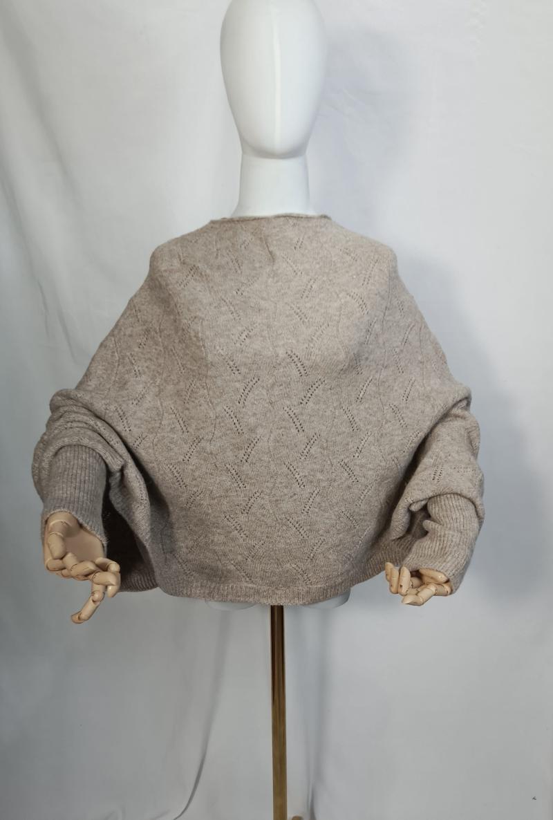 Back view of oversized oatmeal beige pointelle knit sweater with balloon sleeves on white mannequin with wooden hands