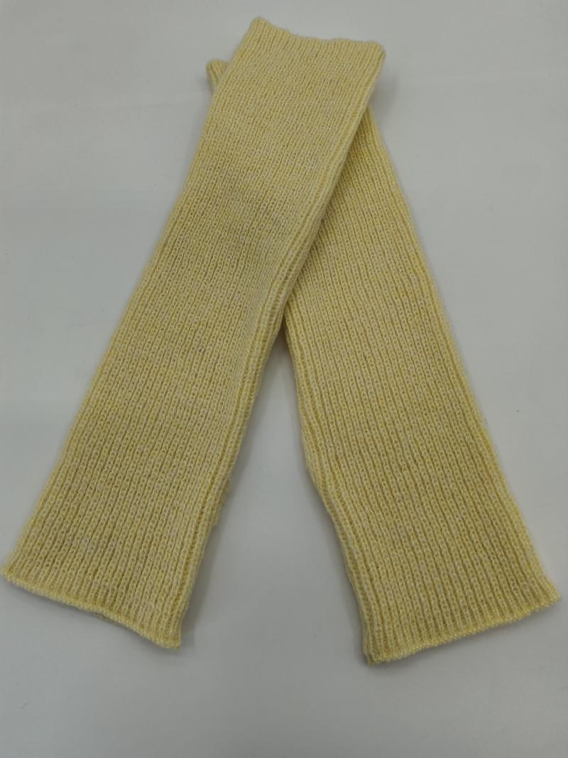 Pair of pale yellow ribbed knit fingerless arm warmers laid flat crossed on white background