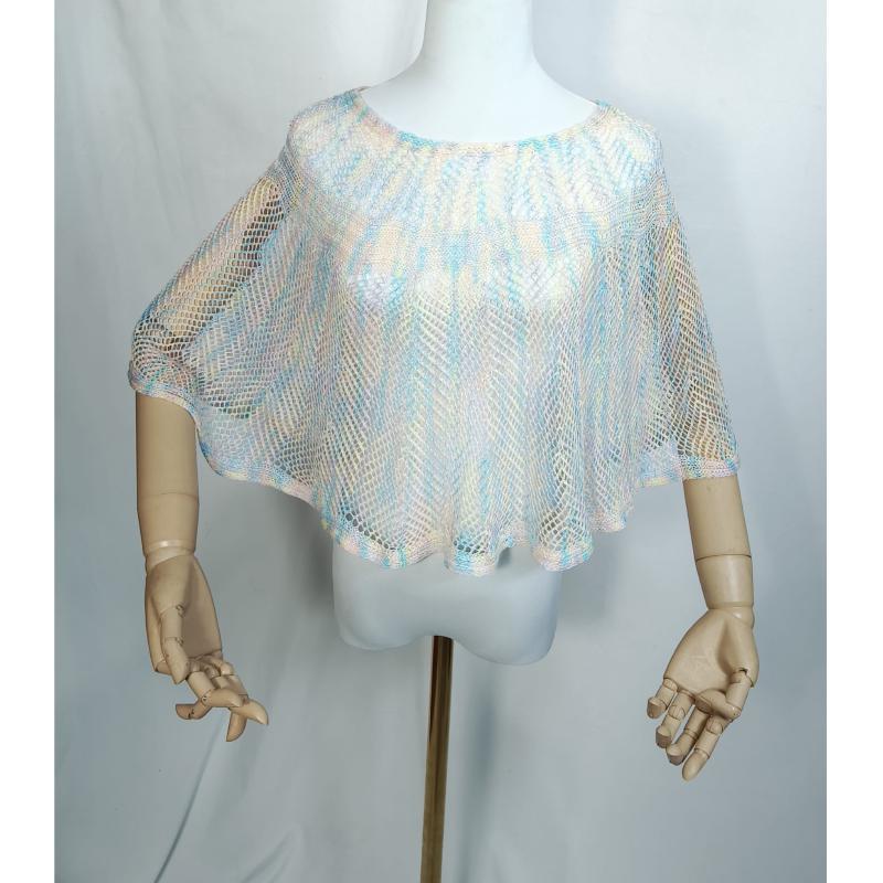 White mannequin wearing a sheer open-knit mesh poncho in pastel blue, peach, and ivory with a loose drape fit
